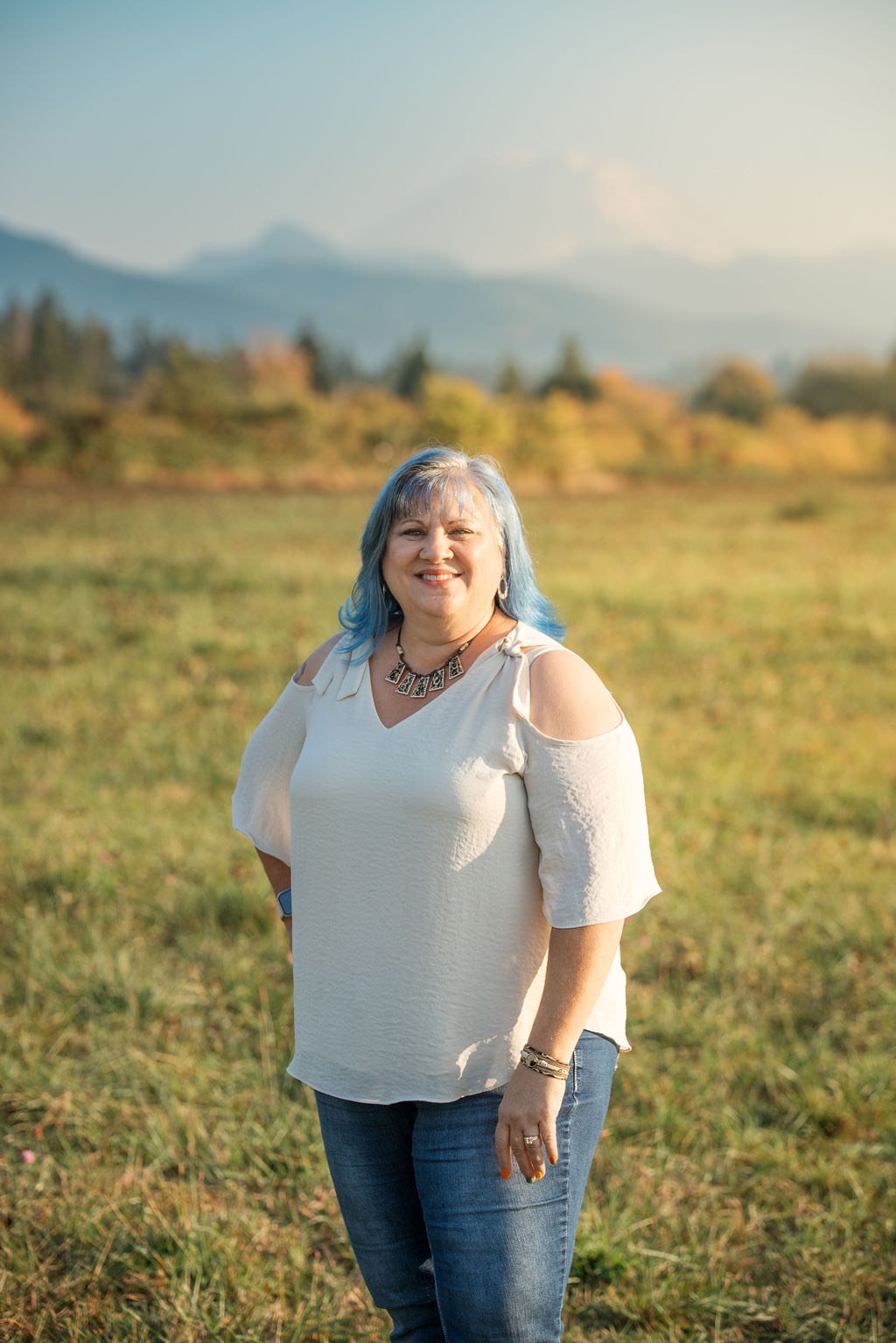 Eva smiling warmly in a sunny field